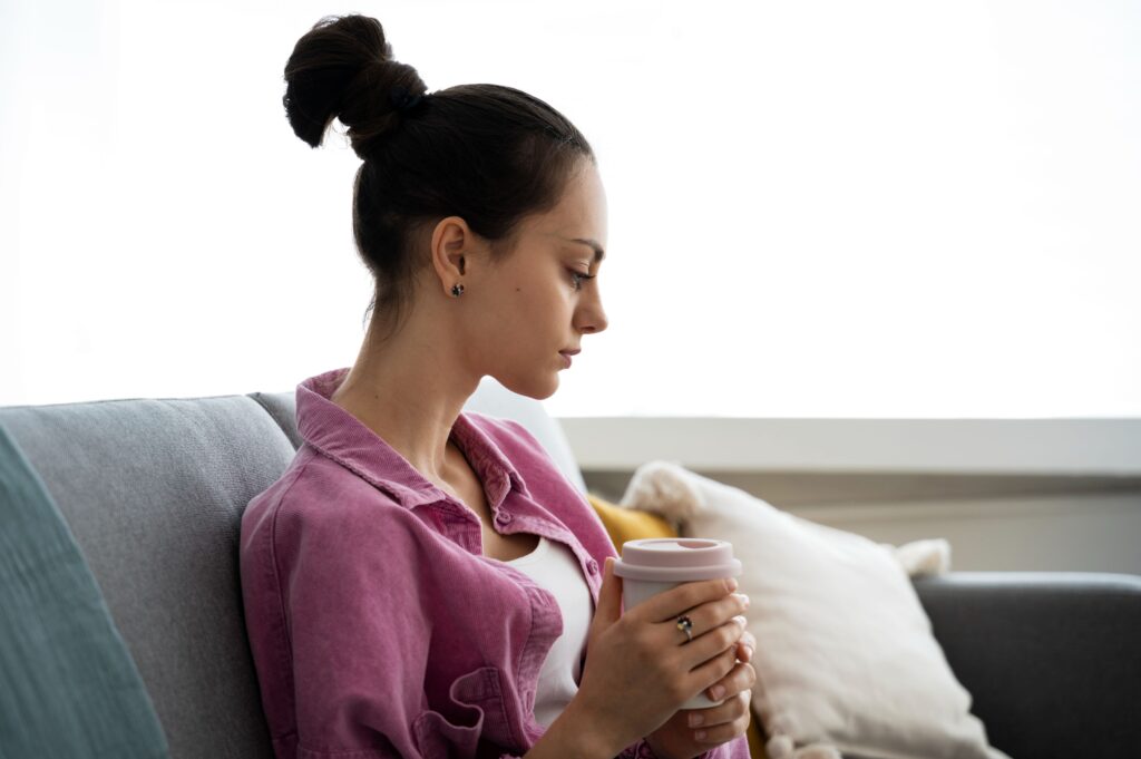 Person sitting alone deep in thought while experiencing chronic stress and mental fatigue