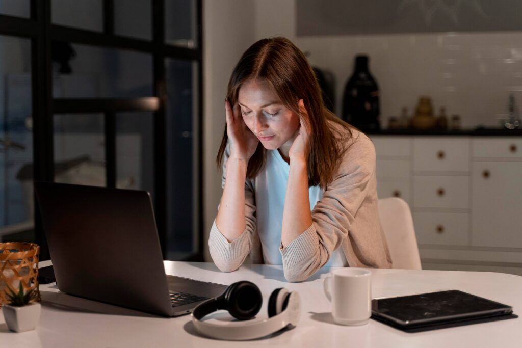 Professional sitting alone after work feeling emotionally exhausted despite finishing daily responsibilities