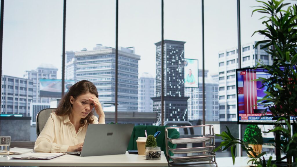 Professional sitting at a desk after work looking mentally exhausted despite completing the day's tasks
