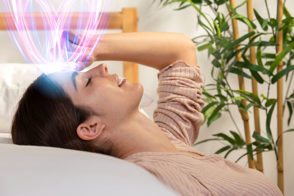 Person sleeping peacefully while calming emotional waves surround the brain, symbolizing overnight emotional processing