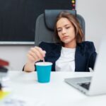 Professional sitting quietly after work feeling mentally exhausted despite completing daily responsibilities