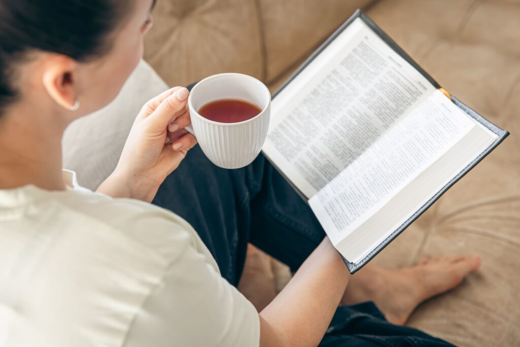 Journal opened to a daily reflection page beside a cup of tea, illustrating a calming evening routine for stress management