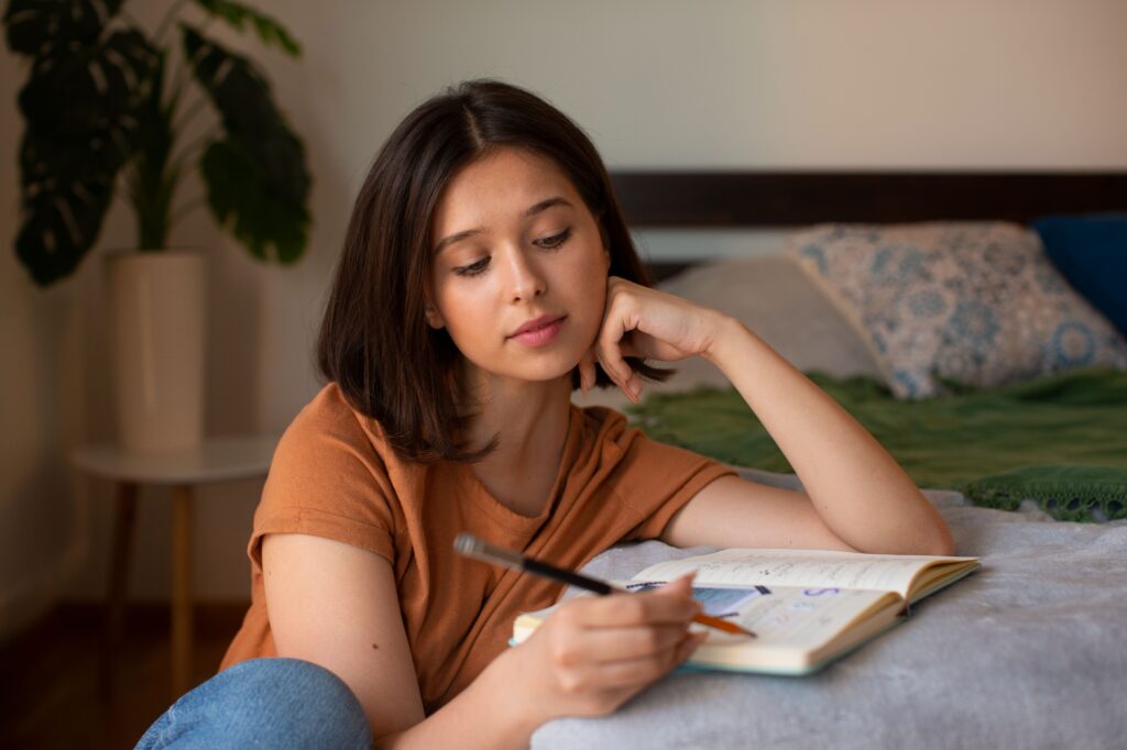 Person journaling during a peaceful morning as part of a calming daily routine