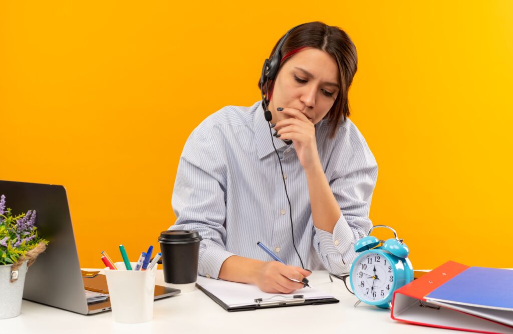 Person sitting at a desk feeling overwhelmed as multiple daily responsibilities begin to pile up