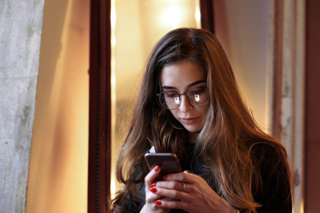Woman feeling emotionally overwhelmed while scrolling through digital content