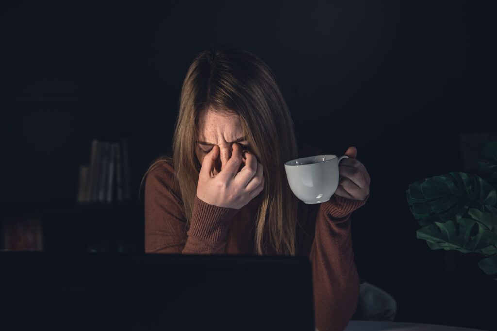 Person becoming visibly frustrated after spilling coffee while already carrying emotional stress from earlier in the day