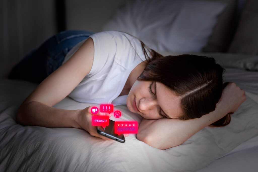 Person lying in bed looking at a glowing smartphone while notifications continue appearing late at night