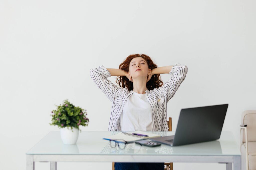 Person stretching their shoulders and neck after a long day at work in a peaceful living room