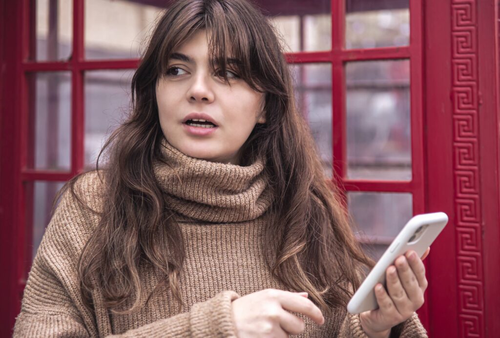 Woman comparing herself with social media content on her smartphone