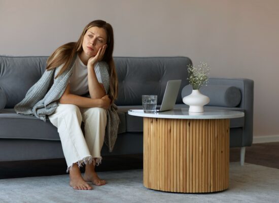 Person sitting comfortably at home while looking mentally tense despite having no urgent responsibilities