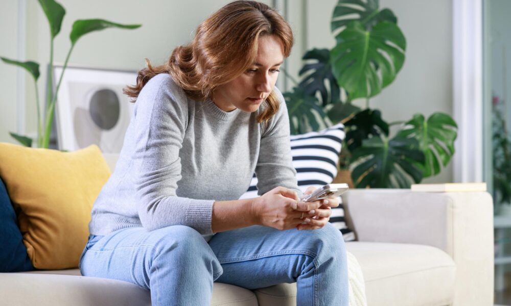 Woman overthinking while looking at something on social media