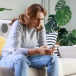 Woman overthinking while looking at something on social media
