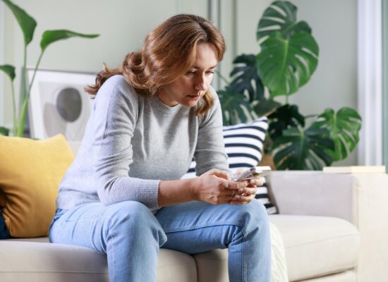 Woman overthinking while looking at something on social media